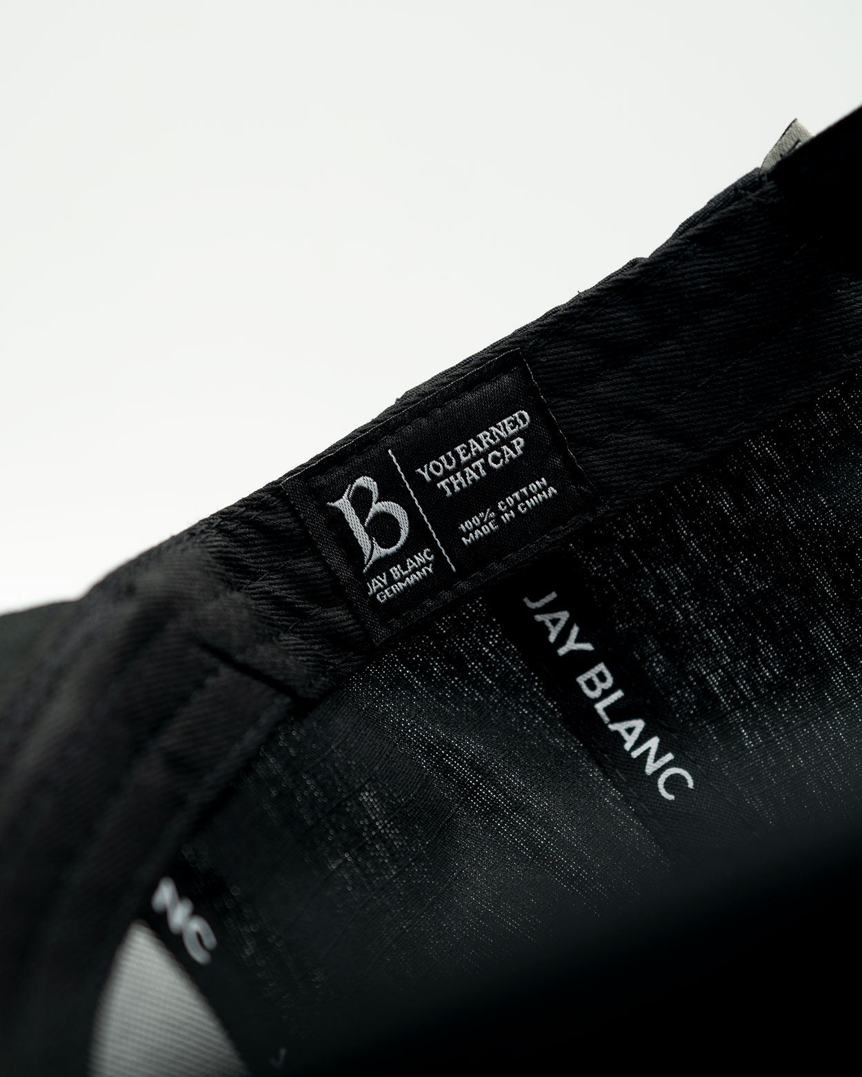 Black-Structured-Brand-Cap-Jay-Blanc-Detail-Inlay